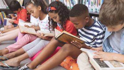 Kids reading books in a library