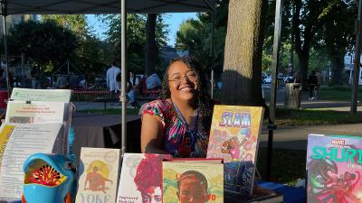 Isabel with free books at an outreach