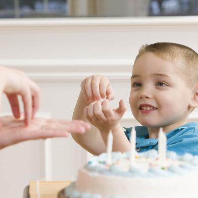 Toddler signing over cake