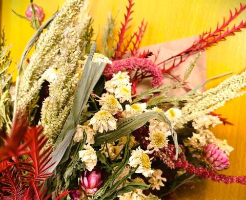 ariel close up photograph of three flower bouquets wrapped in paper