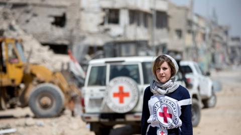 A woman wearing the Red Cross emblem 