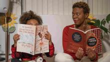 Photo of ZaDora Williams with a child, both reading books.