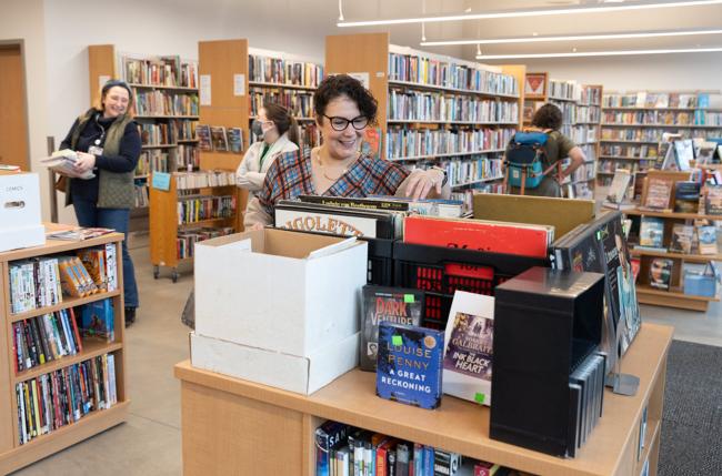 Inside the rose city reads bookstore, a customer is browsing books