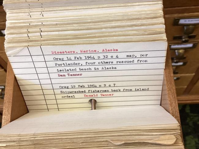 A card in the library’s local newspaper index, with citations for articles about a 1964 shipwreck in Alaska. 